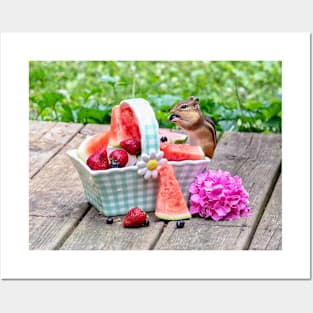 Chipmunk enjoys eating a basket of fruit Posters and Art